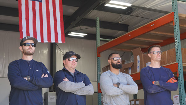 Four NextEra Energy employees, who served in the military, in front of the American flag. Four NextEra Energy employees, who served in the military, in front of the American flag.